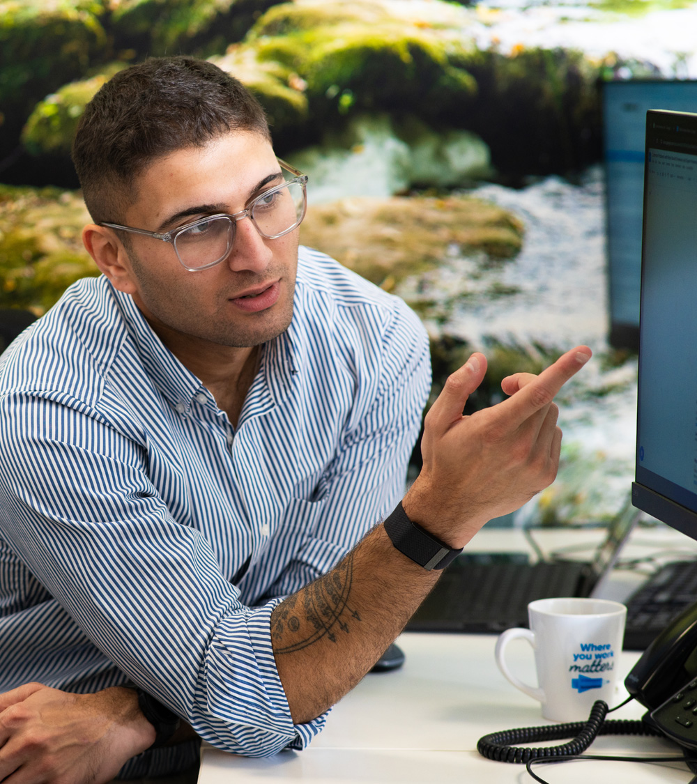 MacnSales strategist reviewing campaign data at a desktop screen