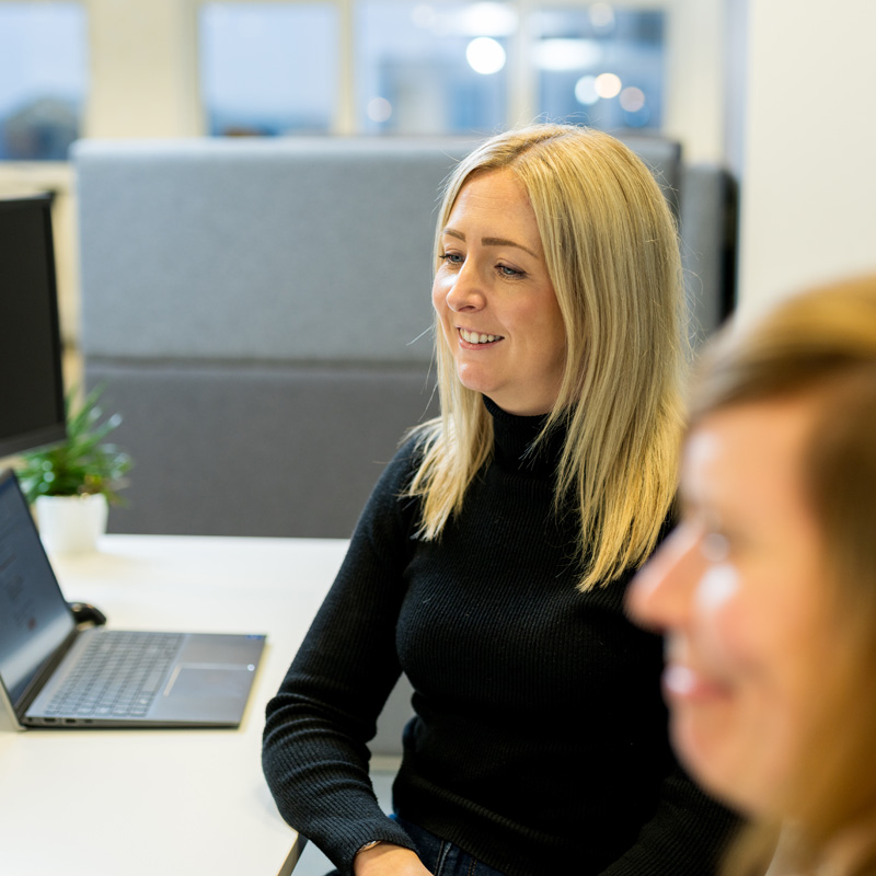 MacnSales team member walking through a live campaign at her desk