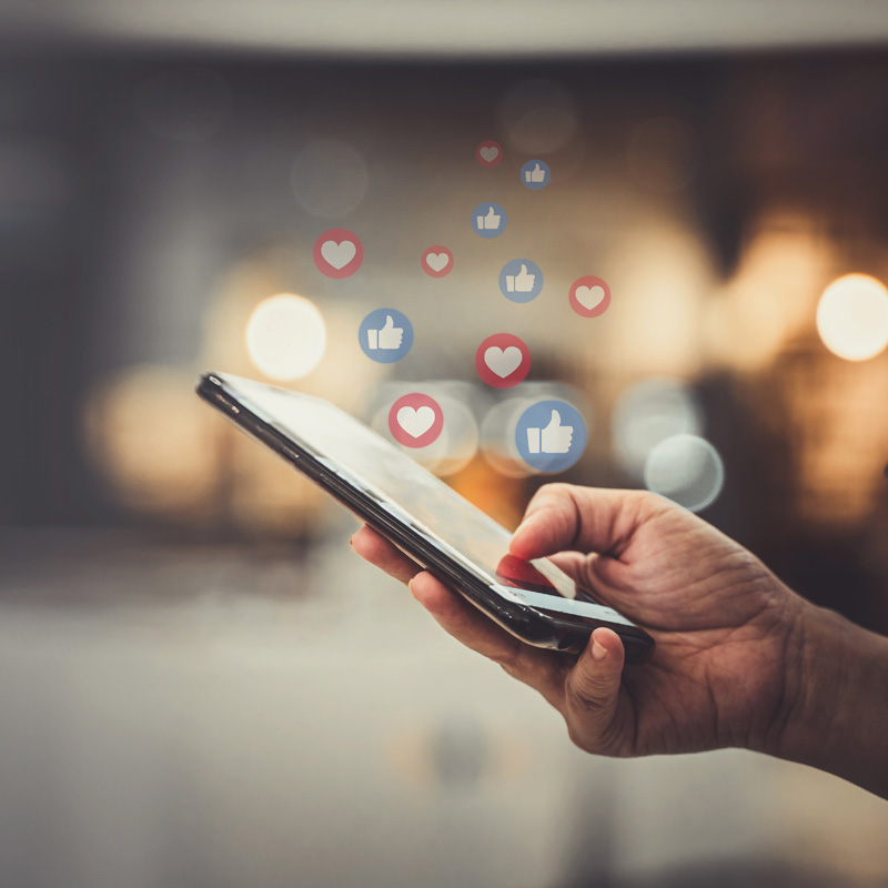 Marketer checking social engagement on a phone